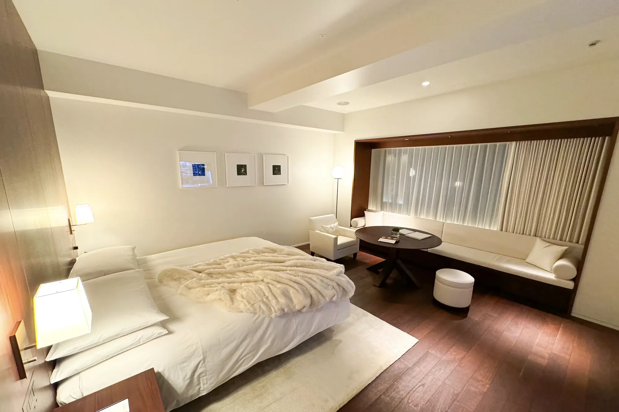 A calm, premium twin hotel room with soft linen and warm lighting