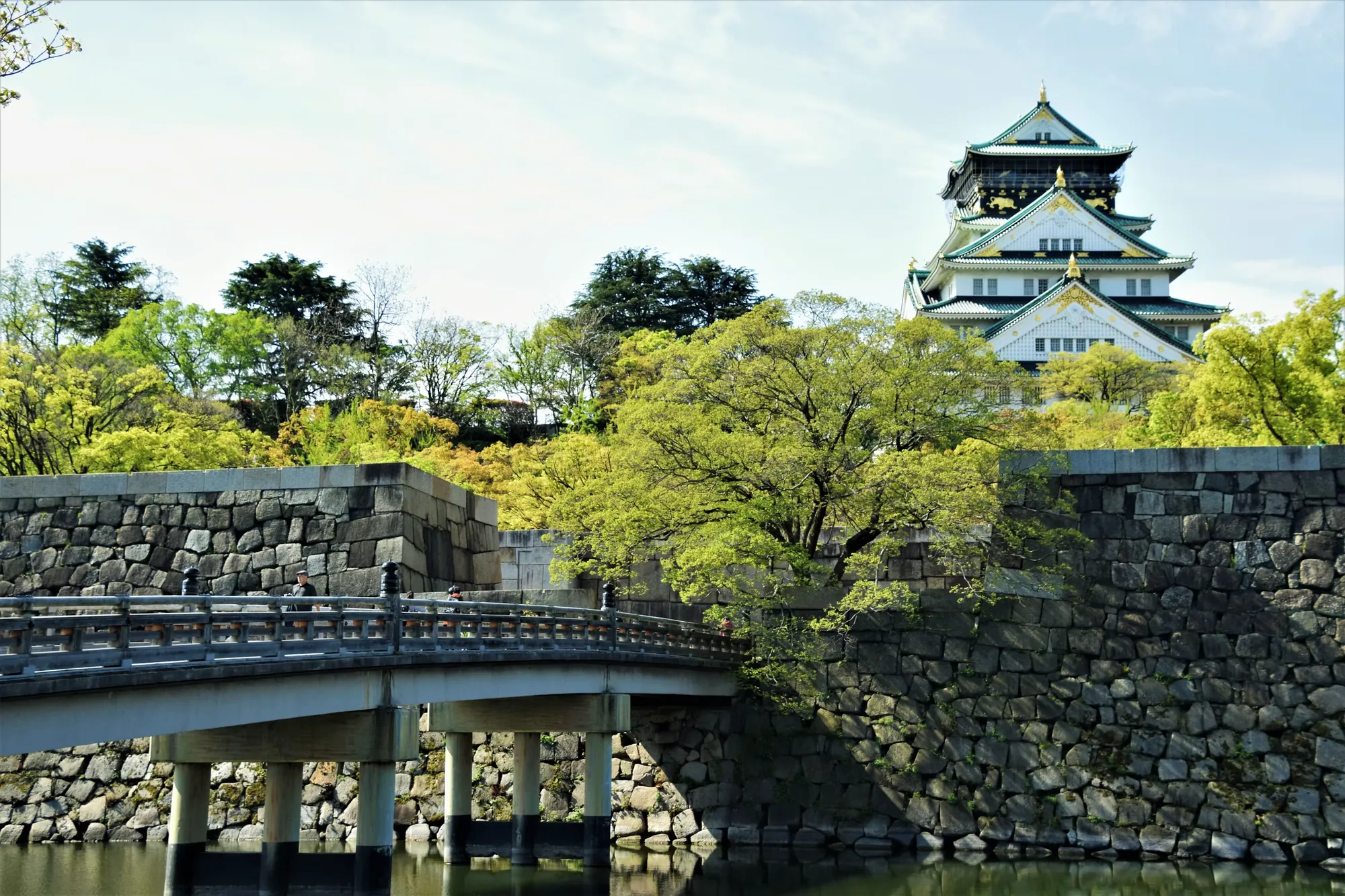 Osaka Castle rising above its stone walls and moat